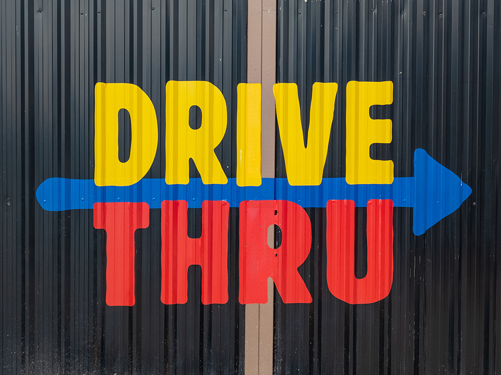 Sign promoting Drive Thru on a black background